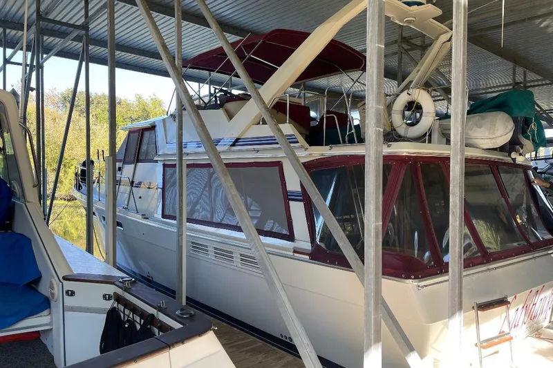 Slide: The Image of 1986 Bayliner 4550 Motoryacht docked under a metal canopy. - 5
