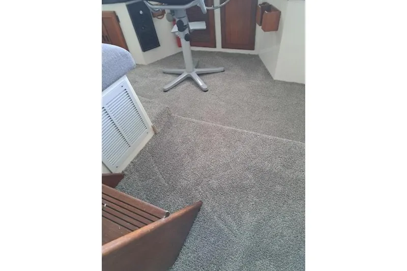 Slide: The Image of Carpeted interior of a 1986 Bayliner 4550 Motoryacht with seating and storage. - 62