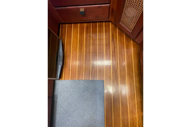 Slide: The Image of 1986 Bayliner 4550 Motoryacht interior with polished wooden flooring and cabinetry. - 63
