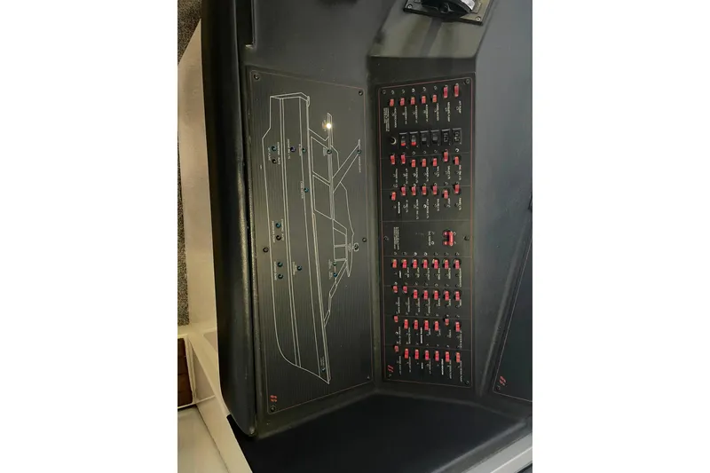 Slide: The Image of Control panel of a 1986 Bayliner 4550 Motoryacht with switches and diagram. - 64