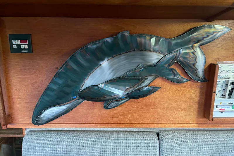 Slide: The Image of Metal dolphin wall art on 1986 Bayliner 4550 Motoryacht interior wood paneling. - 66