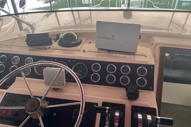 Slide: The Image of 1986 Bayliner 4550 Motoryacht helm with Garmin navigation and classic instrument panel. - 71
