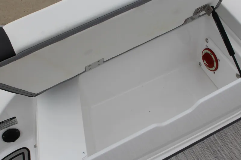 Slide: The Image of 2024 Cobalt 220S boat storage compartment with open lid and visible latch mechanism. - 11