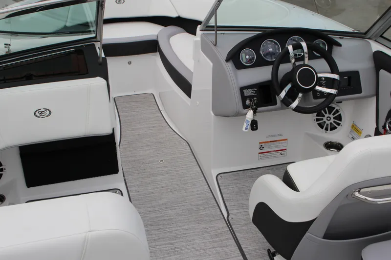 Slide: The Image of 2024 Cobalt 220S boat interior with sleek dashboard and modern steering wheel design. - 12