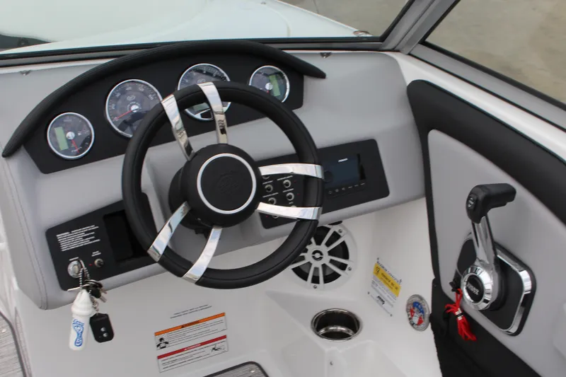 Slide: The Image of 2024 Cobalt 220S boat dashboard with steering wheel and control panel. - 13
