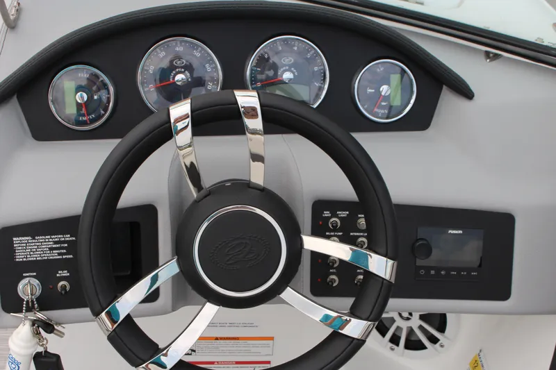 Slide: The Image of Steering wheel and dashboard of 2024 Cobalt 220S boat with gauges and controls. - 14