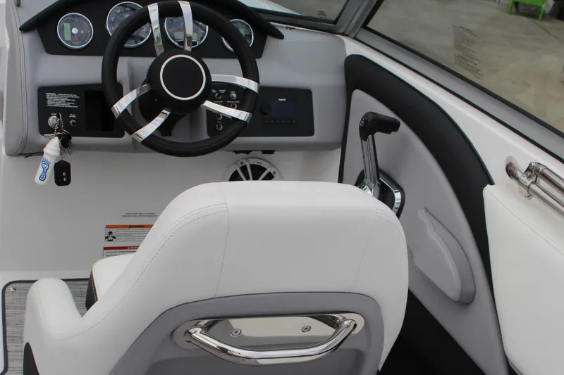 Slide: The Image of 2024 Cobalt 220S boat cockpit with steering wheel and control panel. - 15