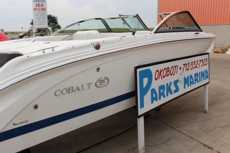Slide: The Image of 2024 Cobalt 220S boat at Parks Marina, Okoboji, displayed outdoors. - 2