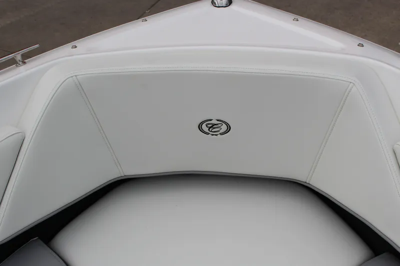 Slide: The Image of 2024 Cobalt 220S boat interior with white cushioned seating and logo detail. - 21