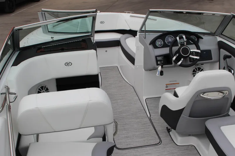 Slide: The Image of 2024 Cobalt 220S boat interior with modern dashboard and white seating. - 24