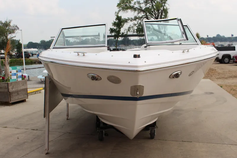 Slide: The Image of 2024 Cobalt 220S boat on display at a marina, front view. - 3