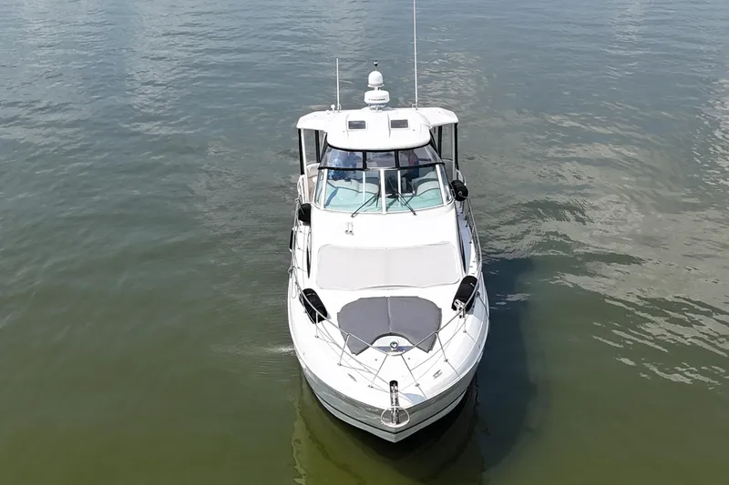 Slide: The Image of 2004 Cruisers Yachts 405 Express Motoryacht on calm water, aerial view. - 12
