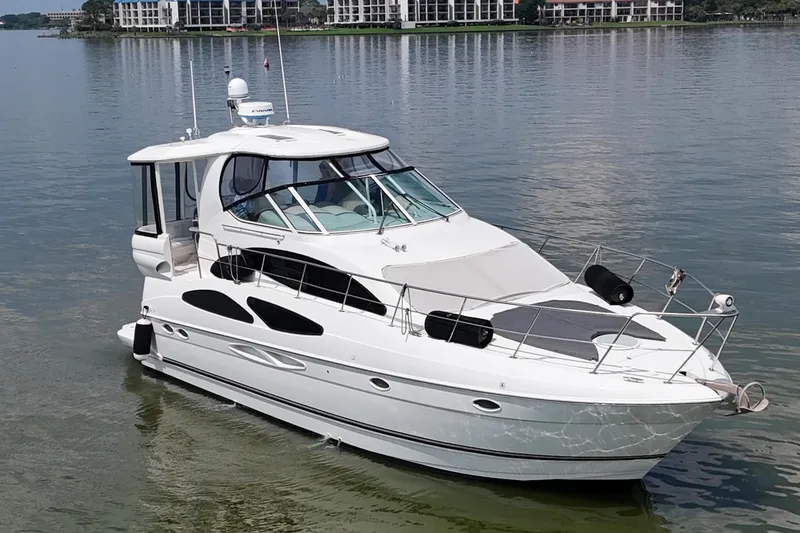 Slide: The Image of 2004 Cruisers Yachts 405 Express Motoryacht on calm water, showcasing sleek design. - 18