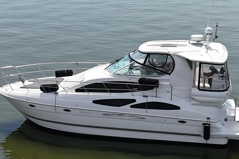 Slide: The Image of 2004 Cruisers Yachts 405 Express Motoryacht on calm water, side view. - 21