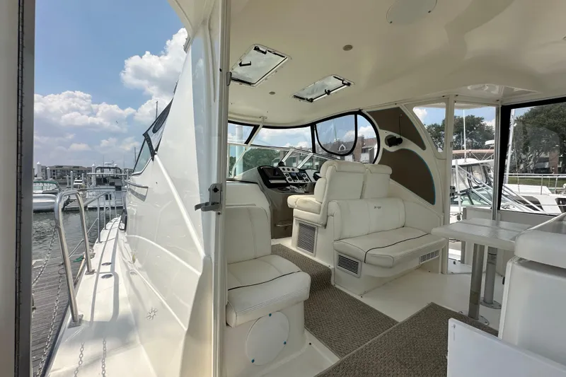 Slide: The Image of 2004 Cruisers Yachts 405 Express Motoryacht interior with helm and seating area. - 23