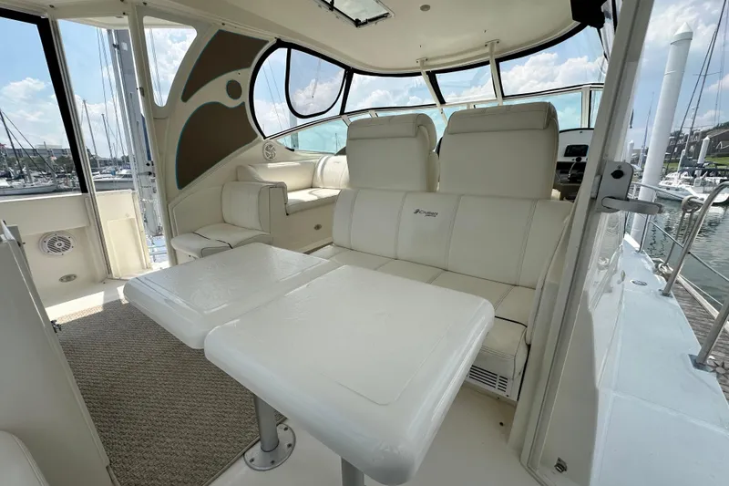 Slide: The Image of 2004 Cruisers Yachts 405 Express Motoryacht interior with white seating and table. - 27
