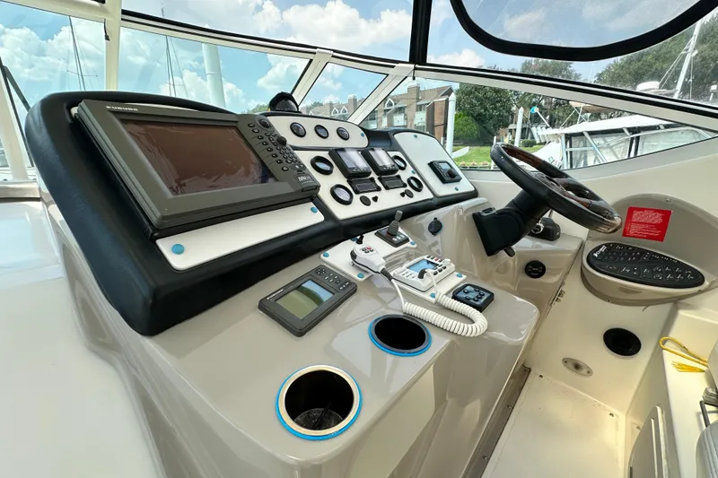 Slide: The Image of 2004 Cruisers Yachts 405 Express Motoryacht helm with navigation equipment and steering wheel. - 36