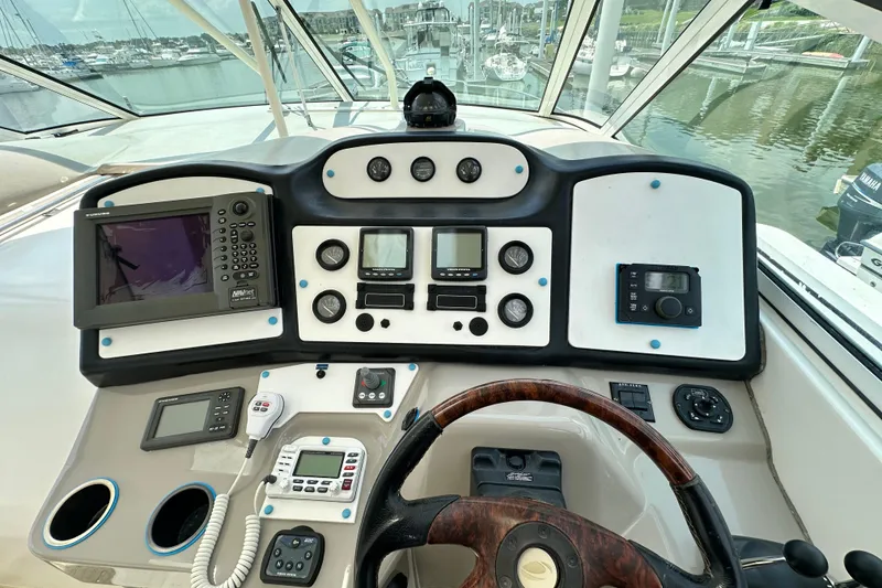 Slide: The Image of 2004 Cruisers Yachts 405 Express Motoryacht helm with navigation and control instruments. - 38