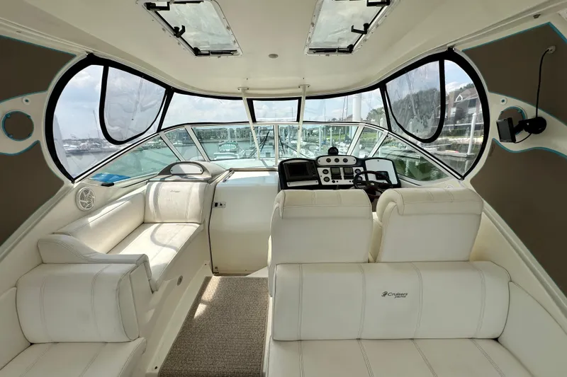 Slide: The Image of 2004 Cruisers Yachts 405 Express Motoryacht interior with white seating and control panel. - 42