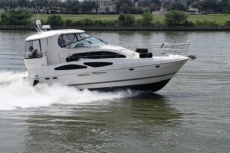 Slide: The Image of 2004 Cruisers Yachts 405 Express Motoryacht cruising on a calm river. - 5