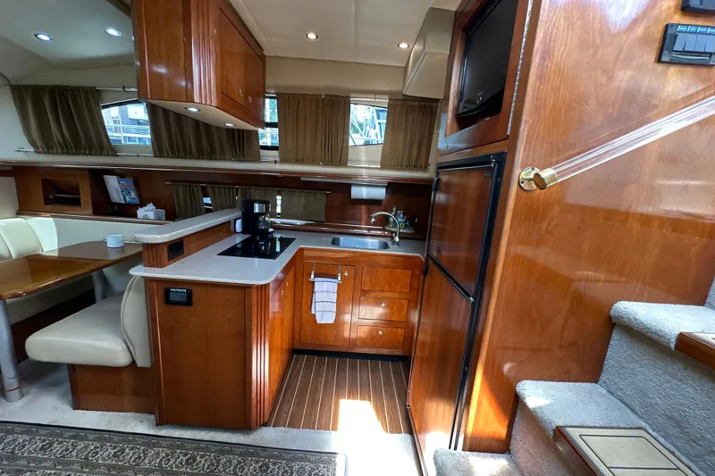 Slide: The Image of Luxurious 2004 Cruisers Yachts 405 Express Motoryacht interior with modern kitchen and dining area. - 56