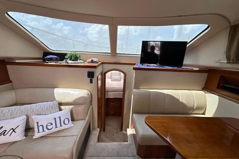Slide: The Image of Interior of 2004 Cruisers Yachts 405 Express Motoryacht with seating, table, and TV. - 64
