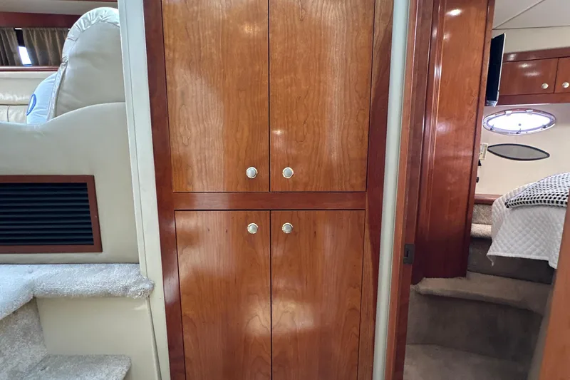 Slide: The Image of Interior of 2004 Cruisers Yachts 405 Express Motoryacht with wooden cabinetry and cozy cabin. - 68