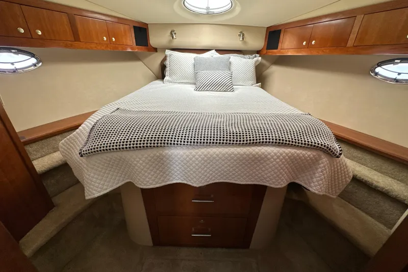 Slide: The Image of Luxurious bedroom in 2004 Cruisers Yachts 405 Express Motoryacht with elegant bedding and wood cabinetry. - 70