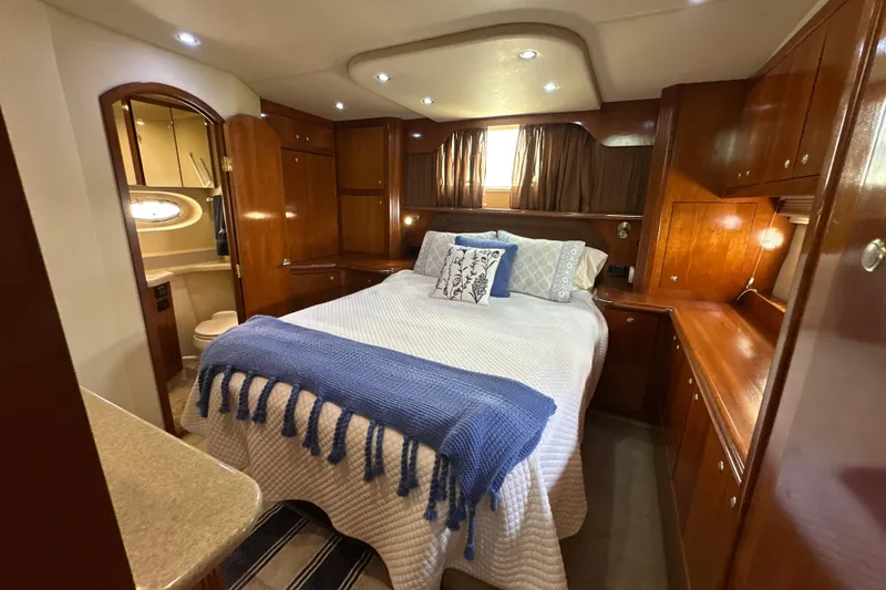 Slide: The Image of Luxurious 2004 Cruisers Yachts 405 Express Motoryacht bedroom with elegant wood finishes. - 80