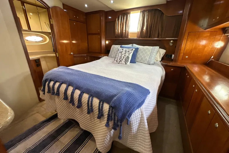 Slide: The Image of Luxurious bedroom in 2004 Cruisers Yachts 405 Express Motoryacht with elegant wood cabinetry. - 82