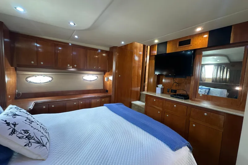 Slide: The Image of Luxurious cabin interior of 2004 Cruisers Yachts 405 Express Motoryacht with wood cabinetry and TV. - 87