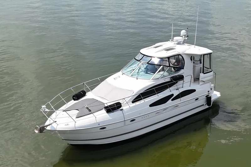 Slide: The Image of 2004 Cruisers Yachts 405 Express Motoryacht on calm water, showcasing sleek design and luxury features. - 9