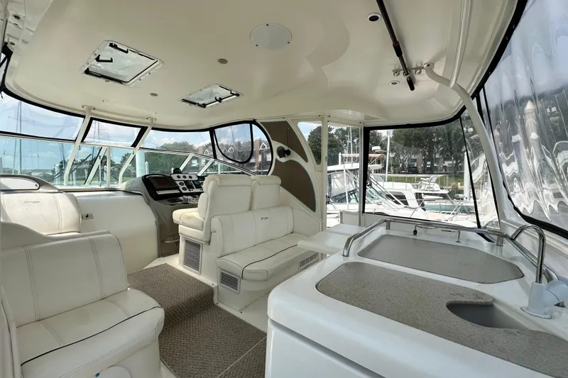 Slide: The Image of 2004 Cruisers Yachts 405 Express Motoryacht interior with helm, seating, and kitchenette. - 24