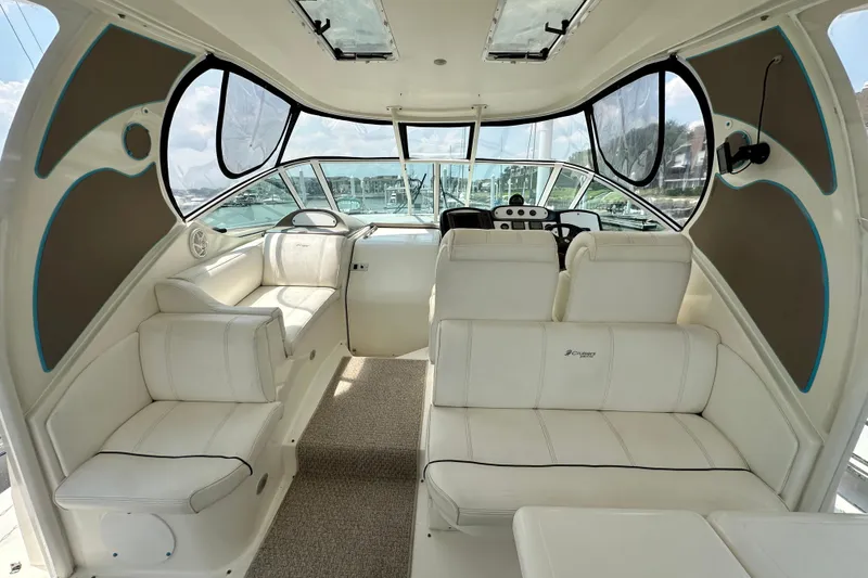 Slide: The Image of 2004 Cruisers Yachts 405 Express Motoryacht interior with white seating and helm. - 28