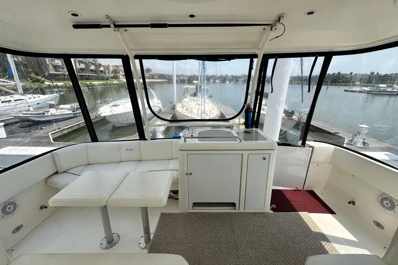 Slide: The Image of 2004 Cruisers Yachts 405 Express Motoryacht interior with seating and marina view. - 29