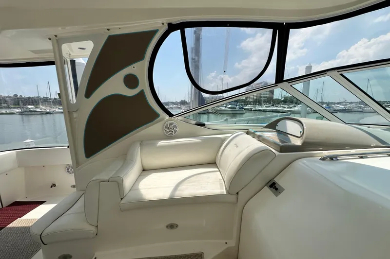 Slide: The Image of 2004 Cruisers Yachts 405 Express Motoryacht interior with marina view through large windows. - 31