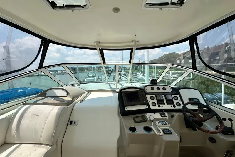 Slide: The Image of 2004 Cruisers Yachts 405 Express Motoryacht helm with panoramic marina view. - 32