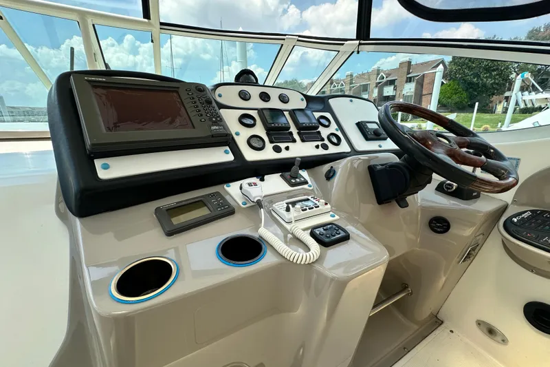 Slide: The Image of 2004 Cruisers Yachts 405 Express Motoryacht helm with navigation equipment and steering wheel. - 35
