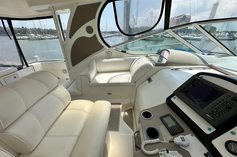 Slide: The Image of 2004 Cruisers Yachts 405 Express Motoryacht interior with luxurious seating and navigation equipment. - 39