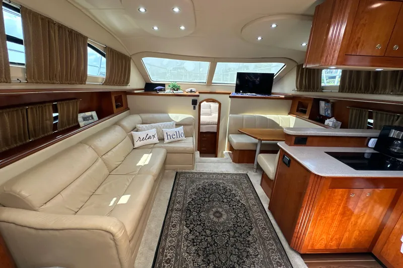 Slide: The Image of Luxurious interior of 2004 Cruisers Yachts 405 Express Motoryacht with leather seating and wood cabinetry. - 48