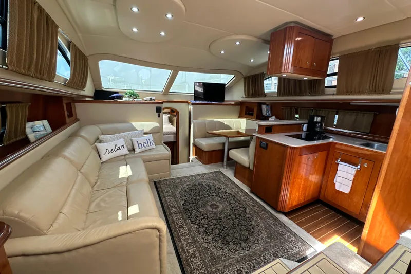 Slide: The Image of Luxurious 2004 Cruisers Yachts 405 Express Motoryacht interior with elegant seating and kitchen area. - 49
