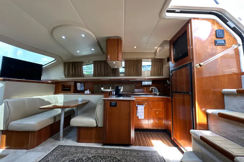 Slide: The Image of Luxurious interior of 2004 Cruisers Yachts 405 Express Motoryacht with modern kitchen and dining area. - 51
