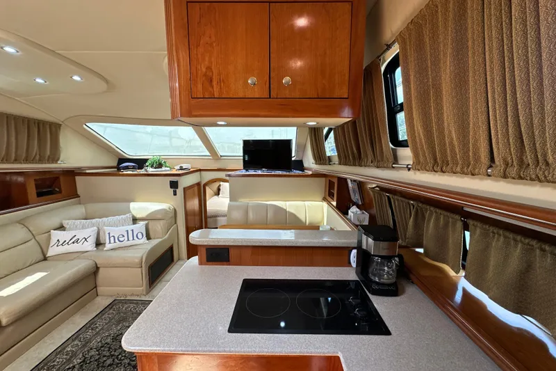 Slide: The Image of Luxurious interior of 2004 Cruisers Yachts 405 Express Motoryacht with modern kitchen and cozy seating. - 58
