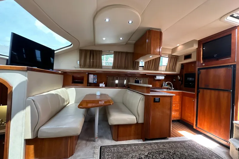 Slide: The Image of Luxurious 2004 Cruisers Yachts 405 Express Motoryacht interior with elegant wood finishes and cozy seating. - 62