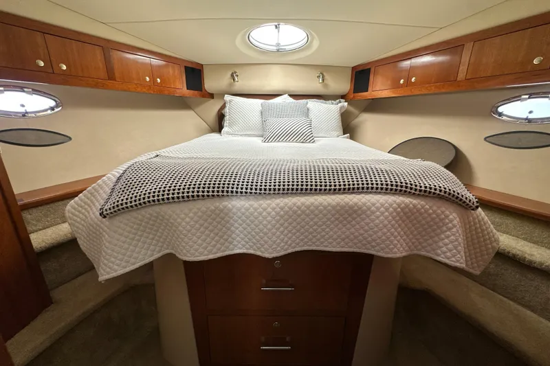Slide: The Image of Luxurious cabin interior of 2004 Cruisers Yachts 405 Express Motoryacht with cozy bedding. - 69