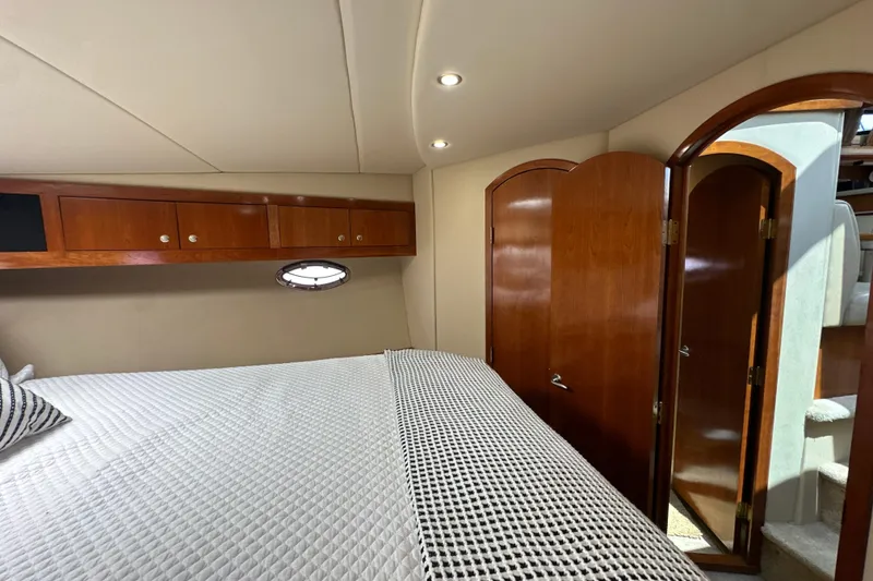 Slide: The Image of Luxurious cabin interior of 2004 Cruisers Yachts 405 Express Motoryacht with wood accents. - 72
