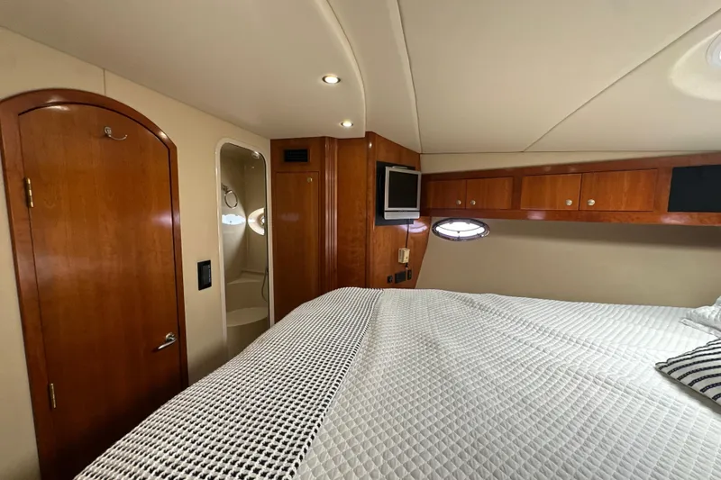Slide: The Image of Luxurious 2004 Cruisers Yachts 405 Express Motoryacht cabin with elegant wood finishes. - 76