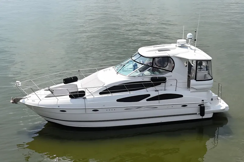 Slide: The Image of 2004 Cruisers Yachts 405 Express Motoryacht on calm water, side view. - 8