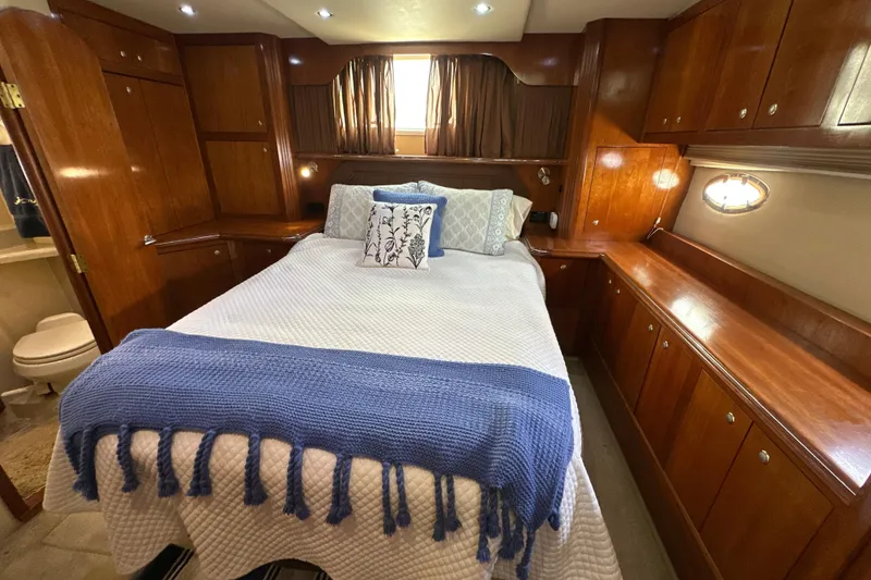Slide: The Image of Luxurious 2004 Cruisers Yachts 405 Express Motoryacht bedroom with elegant wood cabinetry. - 81