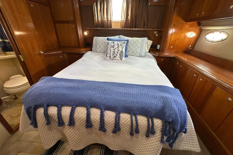 Slide: The Image of Luxurious 2004 Cruisers Yachts 405 Express Motoryacht bedroom with elegant wood cabinetry. - 83